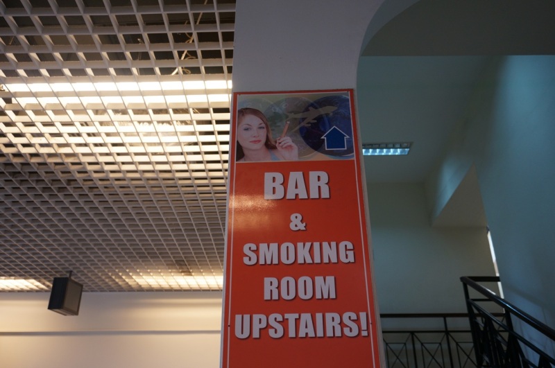 Sign at Athens airport - that's a cigar she's smoking.